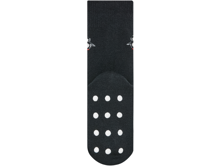 Chaussettes antidérapantes noires avec des points blancs sur la semelle.