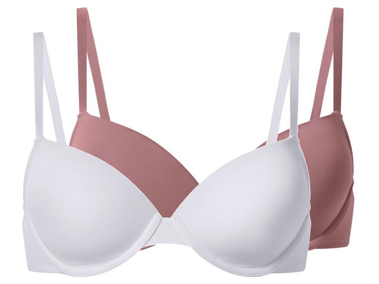Deux soutiens-gorge, un blanc et un rose poudré, avec bretelles réglables.