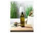 Lampe bouteille design avec abat-jour blanc, sur table.