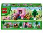 Ensemble Lego Minecraft avec une maison de cochons rose, des figurines et des accessoires.