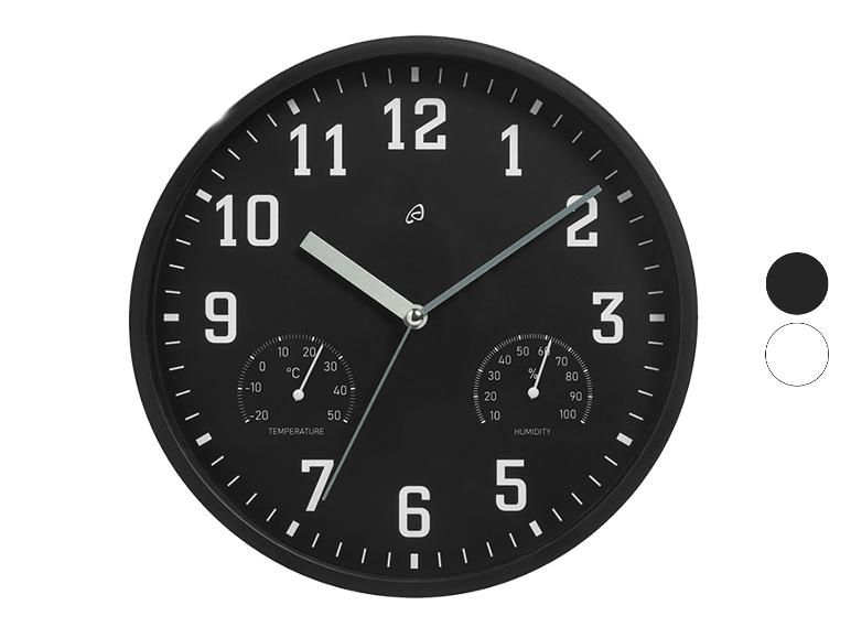 Horloge murale noire avec thermomètre et hygromètre.