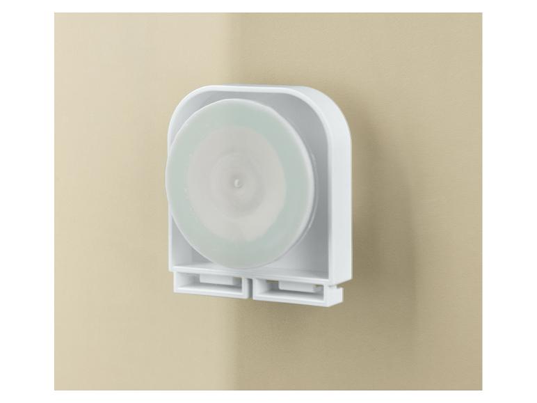 Support mural blanc avec un disque rond vert clair à l'intérieur.