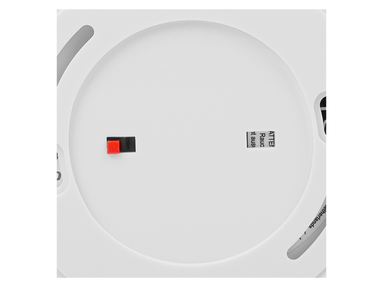 Objet rond blanc avec bouton rouge et noir, texte «ATTEN Raucht aus».