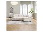 Un salon moderne avec un grand canapé d'angle beige, une table d'appoint noire et une plante en pot.