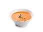 Un bol de soupe orange avec un brin de romarin.