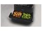 Friteuse à air Philips noire avec deux paniers remplis de brocolis et de croquettes.