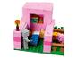 Ensemble LEGO Minecraft avec une maison rose, un lit, un cochon et une figurine.