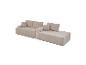 Canapé modulaire en velours côtelé beige avec coussins, formant une configuration de méridienne.