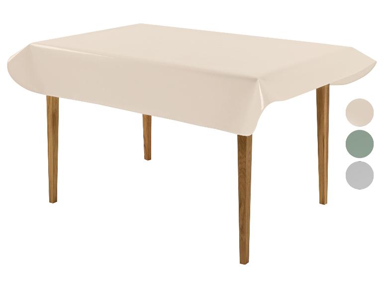 Nappe beige sur table en bois avec échantillons de couleurs beige, vert et gris.