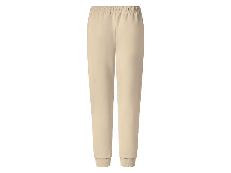 Pantalon de jogging beige avec taille élastique et chevilles côtelées.