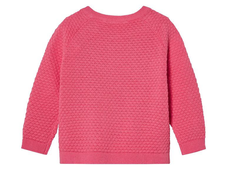Pull rose pour bébé, en maille texturée.