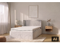 Chambre à coucher avec un lit rembourré gris, un matelas et des tables de chevet.