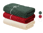 Serviettes LIVARNO® Frottier: vert foncé, rouge et crème, nouées avec un ruban blanc.