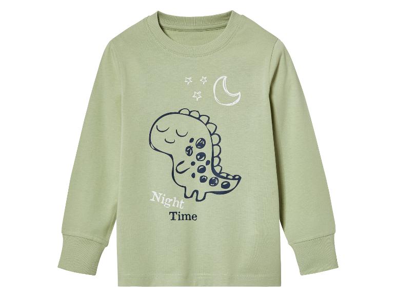 Un t-shirt à manches longues vert avec un imprimé de dinosaure.