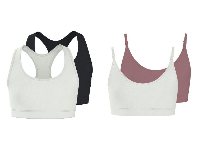 Deux ensembles de soutiens-gorge de sport pour femmes : noir et blanc dos nageur, et blanc et rose style caraco.