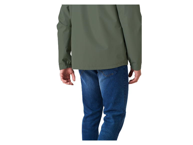 Un homme portant une veste vert olive et un jean bleu.