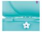 Réducteur de siège de toilette turquoise pour enfant avec bouton en forme d'étoile.