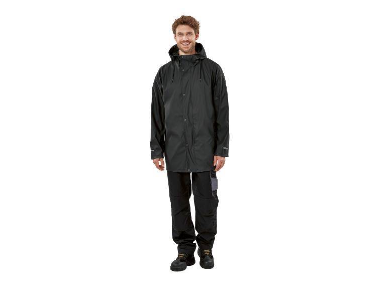 Un homme porte un imperméable noir et un pantalon de travail.