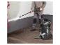 Homme utilisant un nettoyeur haute pression Parkside pour nettoyer un mur et une terrasse en bois.