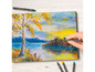 Une main utilisant un pastel soluble dans l'eau Crelando pour dessiner un paysage avec un arbre et un lac.