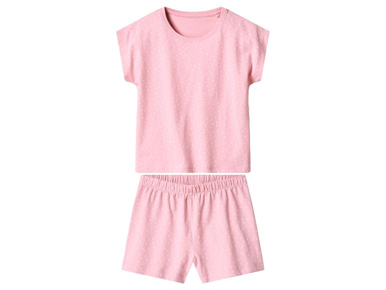Pyjama deux pièces rose pour fille à pois blancs.