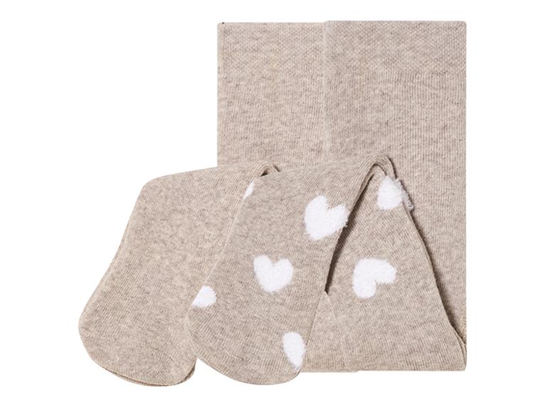 Collants beiges à coeurs blancs.