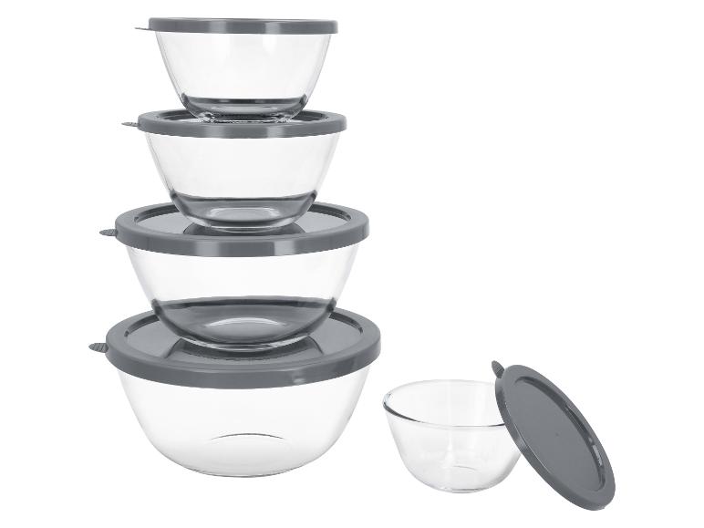 Ensemble de bols en verre avec couvercles gris, empilés et un à côté.