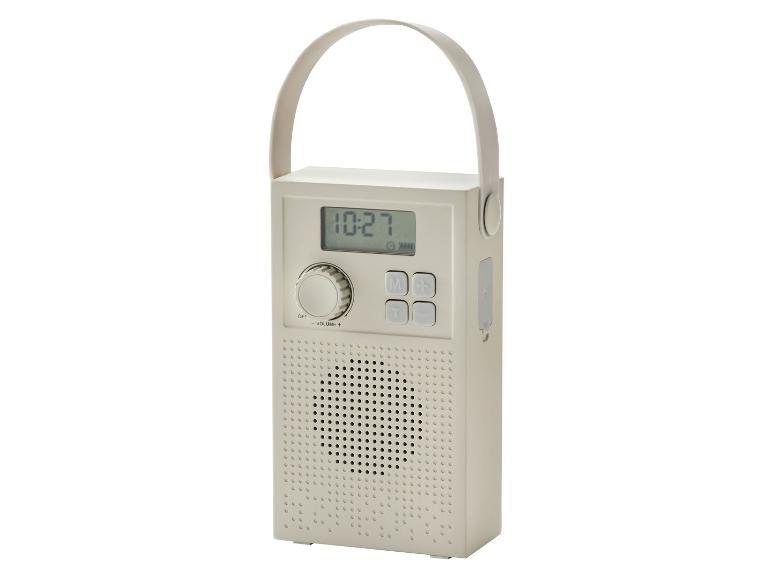 Radio portable beige avec écran numérique, boutons et poignée.