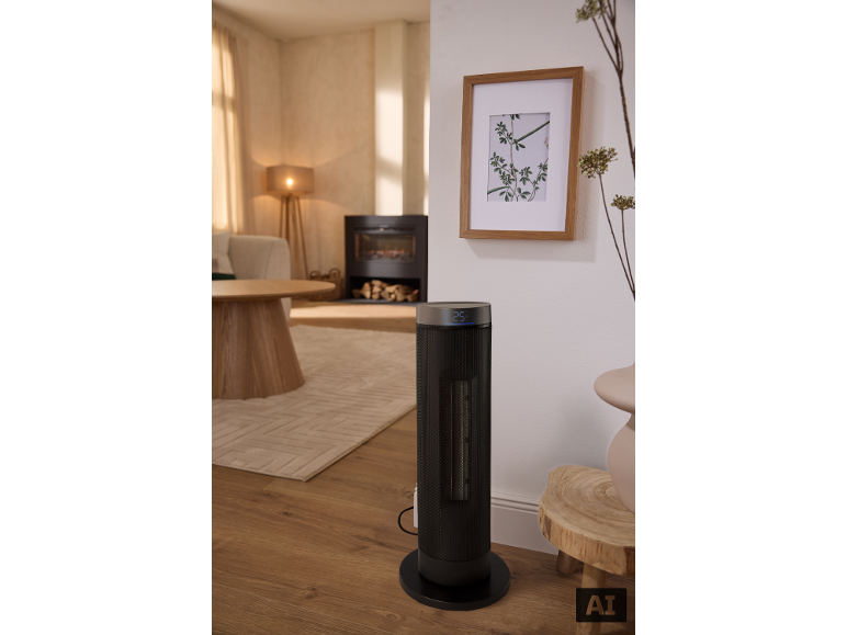 Radiateur tour noir avec affichage 25°C dans un salon moderne.