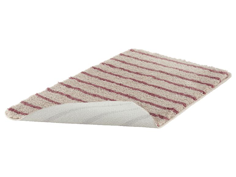 Tapis de bain rayé beige et violet, avec dessous antidérapant visible.