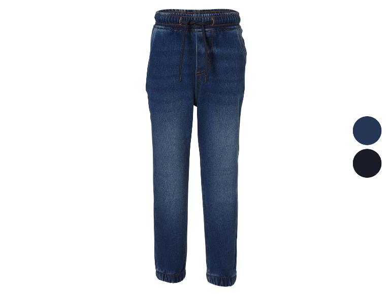 Jean jogger garçon en denim bleu, avec taille élastique et cordon de serrage.
