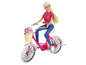 Une poupée sur un vélo rose avec un panier