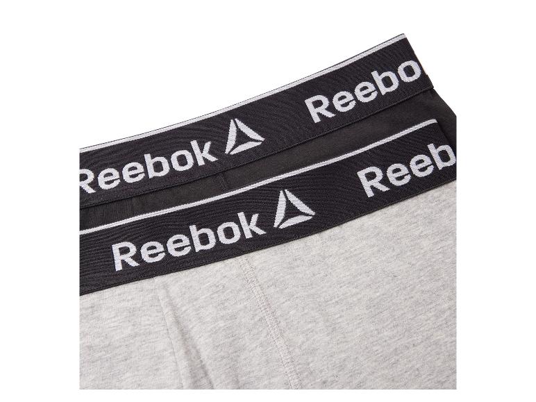 Boxers Reebok gris et noirs avec logo sur la ceinture.