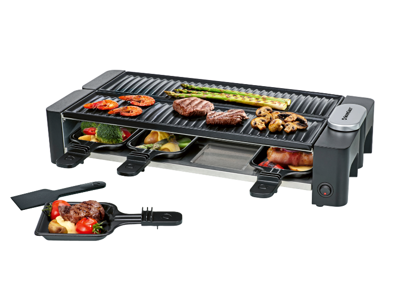 Appareil à raclette électrique avec légumes, viande et fruits de mer grillés.