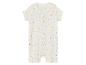 Une grenouillère blanche pour bébé à manches courtes et à fermeture éclair, recouverte de pois de couleurs.