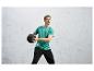 Un homme en t-shirt vert et pantalon noir tenant un ballon de médecine.