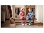 Deux enfants rieurs en combinaisons de pluie et bottes en caoutchouc assis sur un banc dans un couloir.