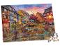 Puzzle représentant une ville pittoresque au bord d'un canal au coucher du soleil, avec des maisons colorées et des vélos.