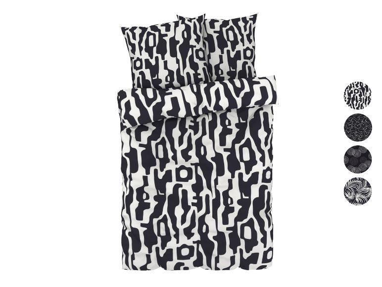 Une parure de lit avec un motif abstrait noir et blanc.