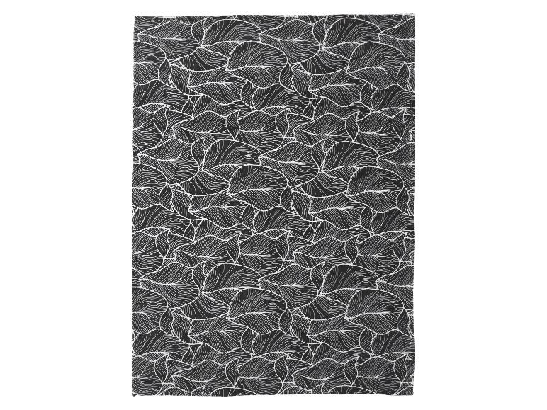 Tissu noir avec un motif de feuilles blanches et ondulées