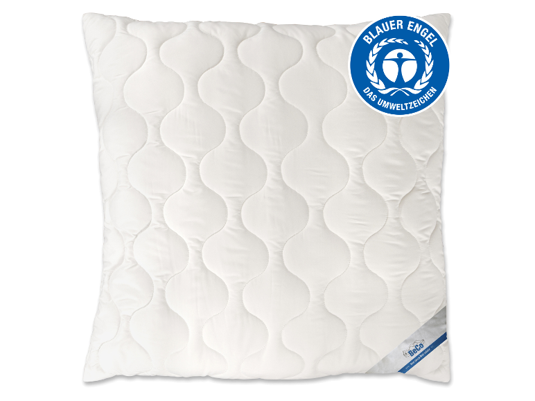 Oreiller blanc matelassé avec motif ondulé et logo écologique Blauer Engel.
