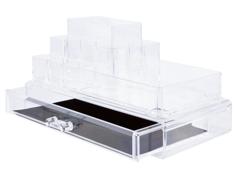 Une boîte de rangement transparente avec tiroirs pour le maquillage ou les bijoux.