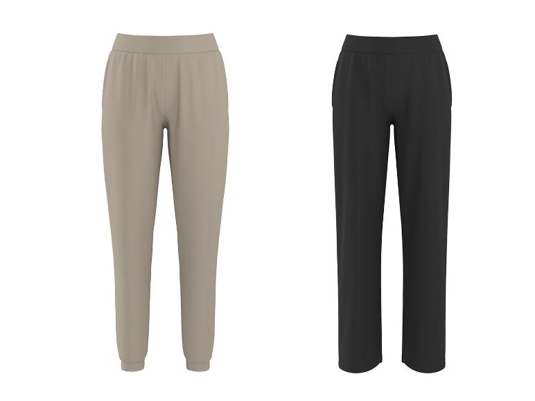 Deux pantalons de survêtement, un beige et un noir, avec taille élastique et poches.
