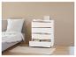Une commode blanche avec des accents en bois dans une chambre à coucher.