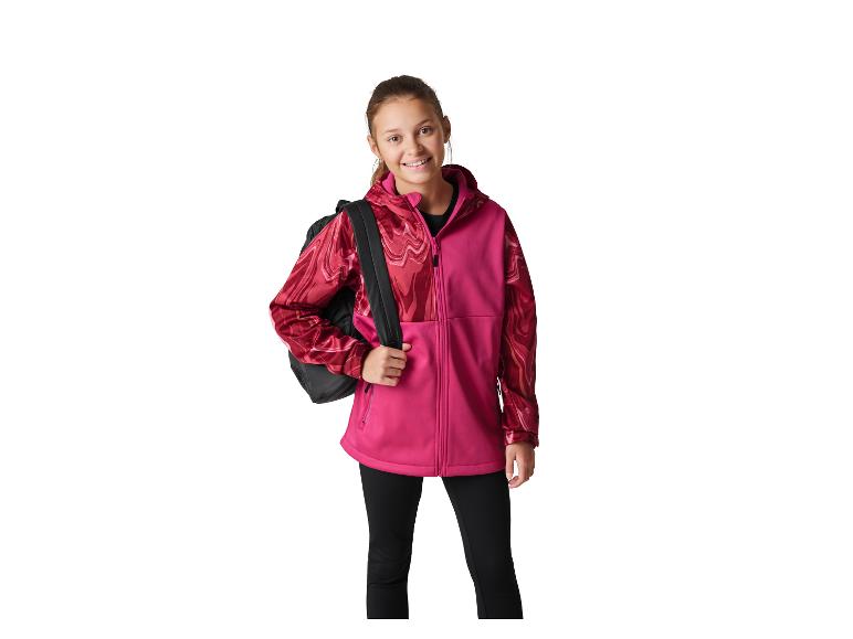 Fille souriante en veste rose et rouge avec un sac à dos noir.