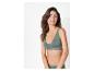 Une femme porte un soutien-gorge et une culotte verts.