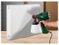 Pistolet à peinture PARKSIDE utilisé pour peindre un radiateur blanc.