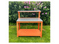 Un établi en bois orange avec un plan de travail en métal et une étagère de rangement.