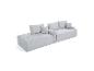 Canapé modulaire gris avec coussins, au design côtelé moderne.