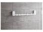 Un porte-serviettes blanc avec des crochets, fixé à un mur de carreaux gris.